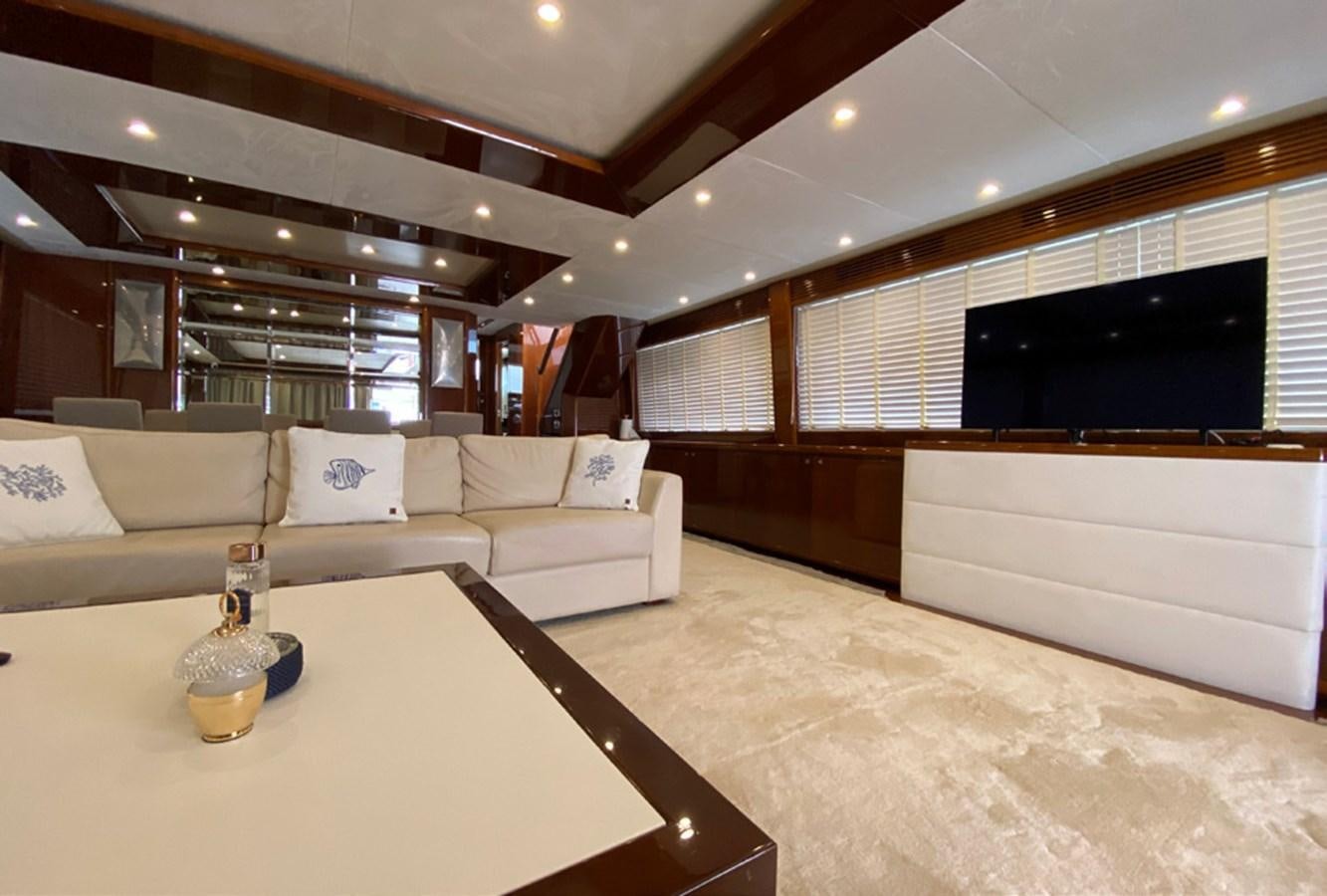 a living room with a couch and a tv aboard SEZI MEGA Yacht for Sale