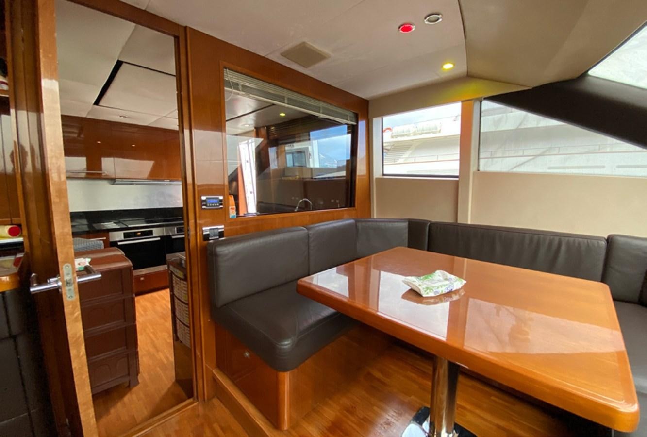 a room with a table and chairs aboard SEZI MEGA Yacht for Sale