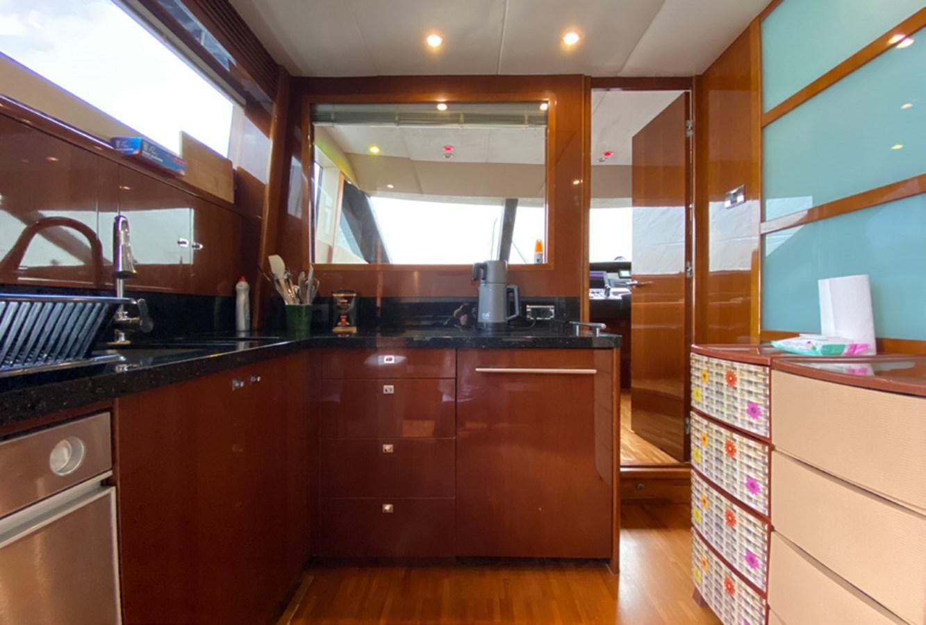 a kitchen with wooden cabinets aboard SEZI MEGA Yacht for Sale