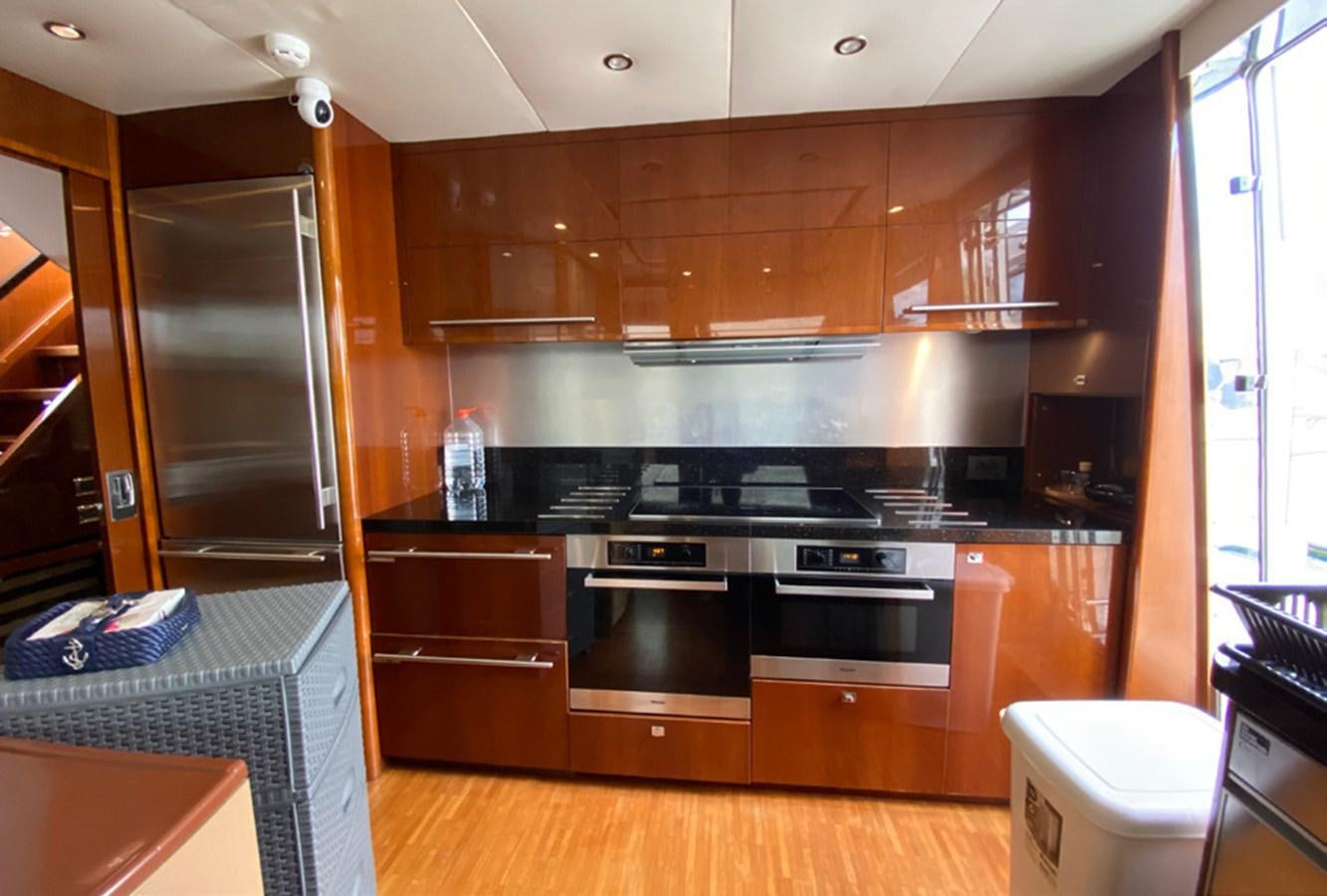 a kitchen with wooden cabinets aboard SEZI MEGA Yacht for Sale