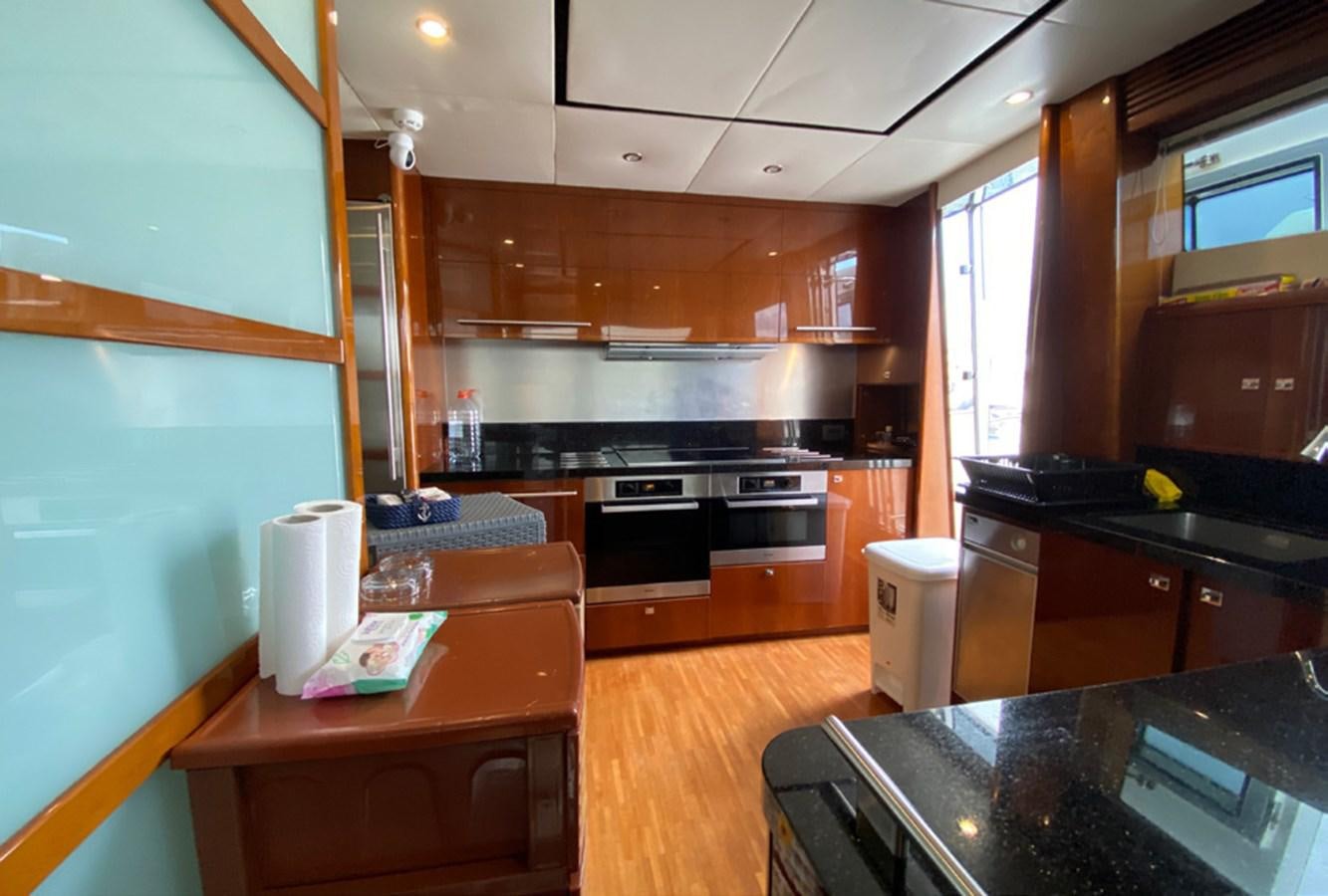 a kitchen with wooden cabinets aboard SEZI MEGA Yacht for Sale