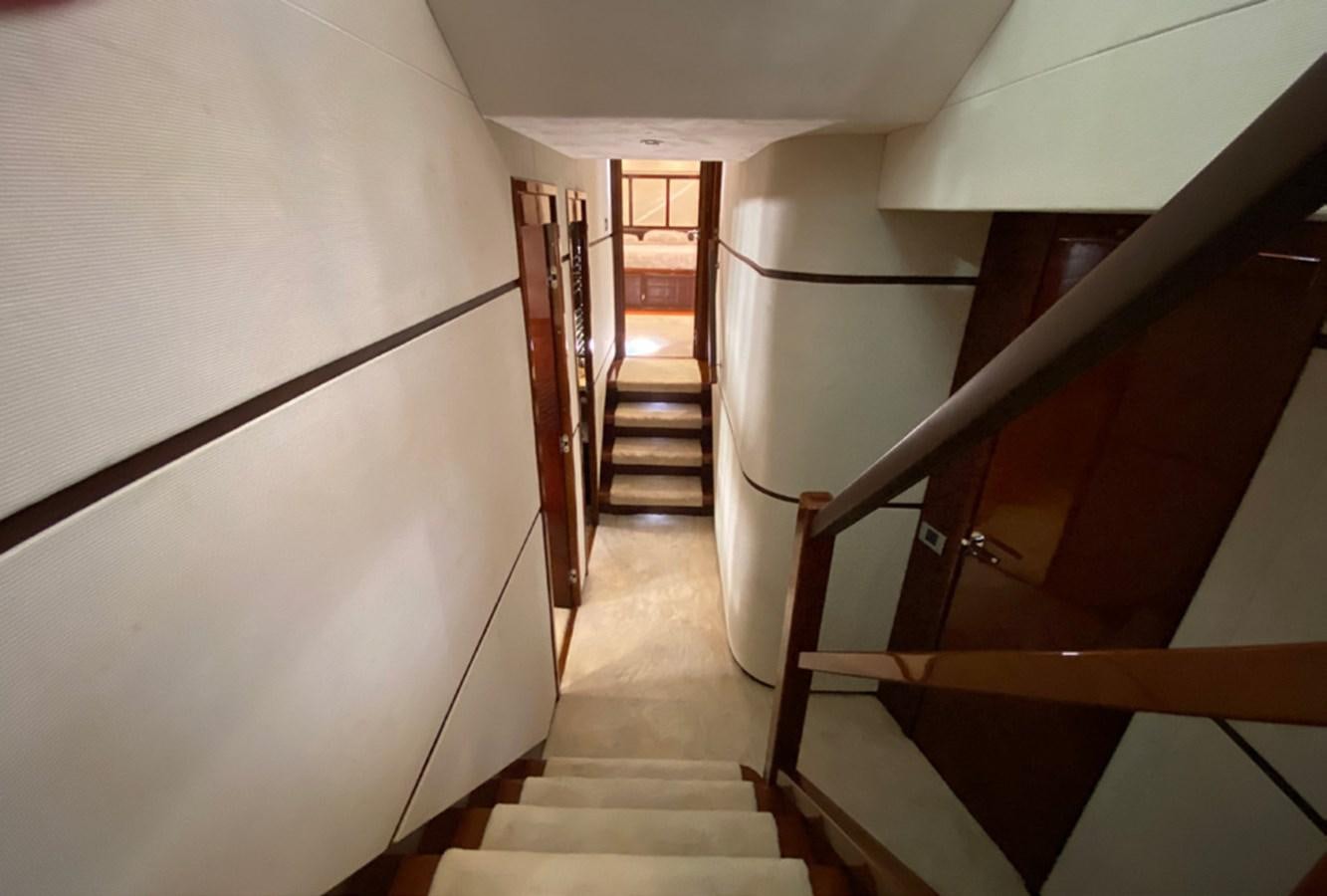 a long hallway with white walls aboard SEZI MEGA Yacht for Sale