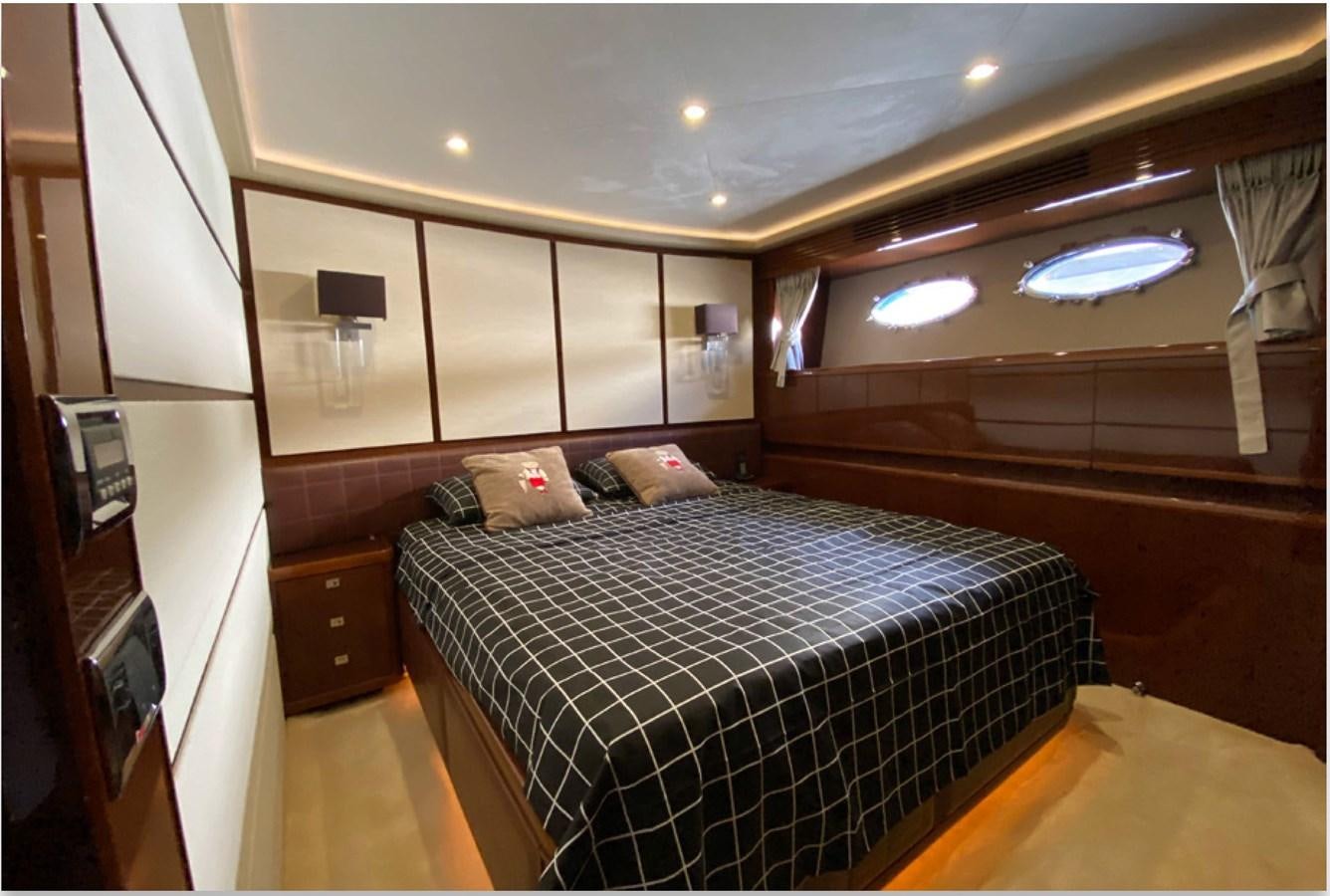 a bedroom with a bed and a desk aboard SEZI MEGA Yacht for Sale