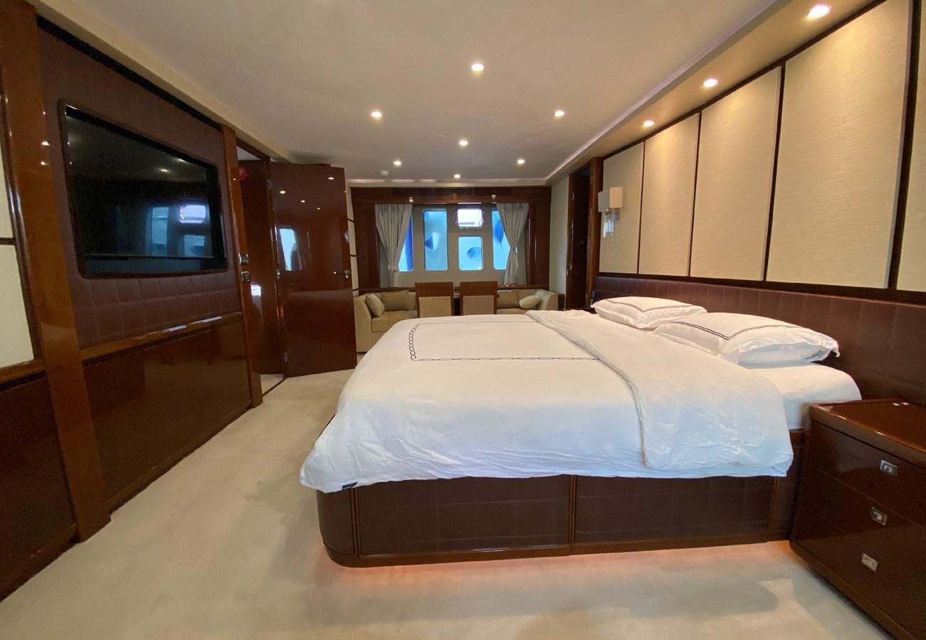 a room with a bed and a television aboard SEZI MEGA Yacht for Sale