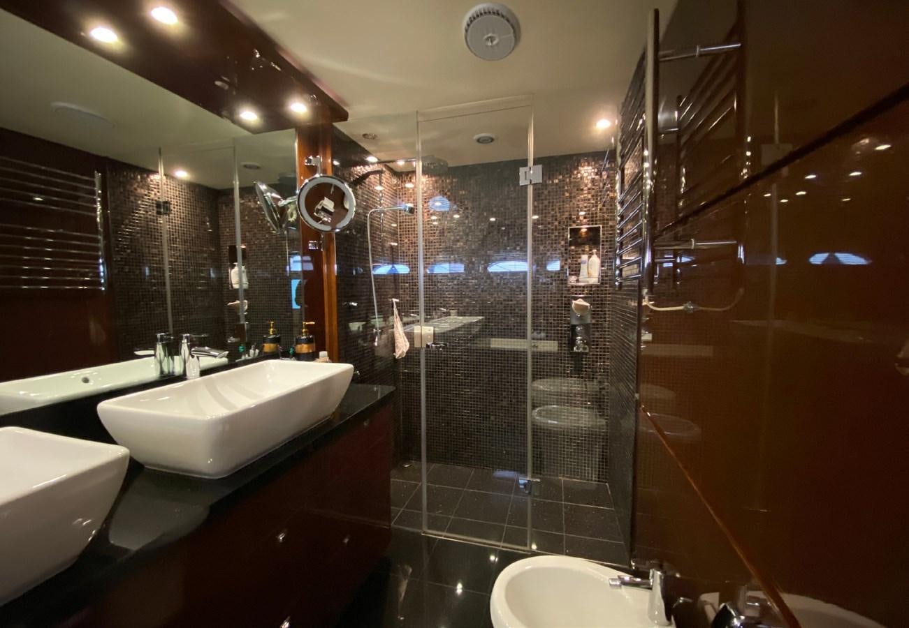a bathroom with a glass shower aboard SEZI MEGA Yacht for Sale