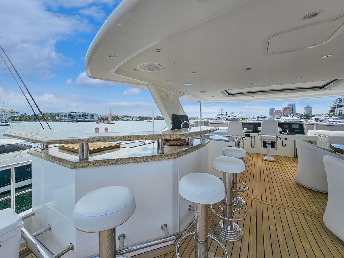 a boat with stools and tables aboard O A Yacht for Sale