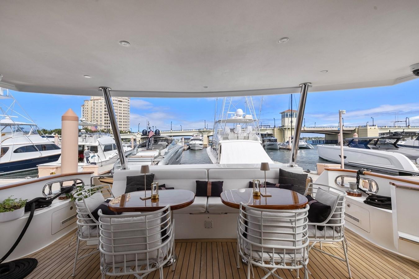 a deck with a table and chairs on it aboard O A Yacht for Sale