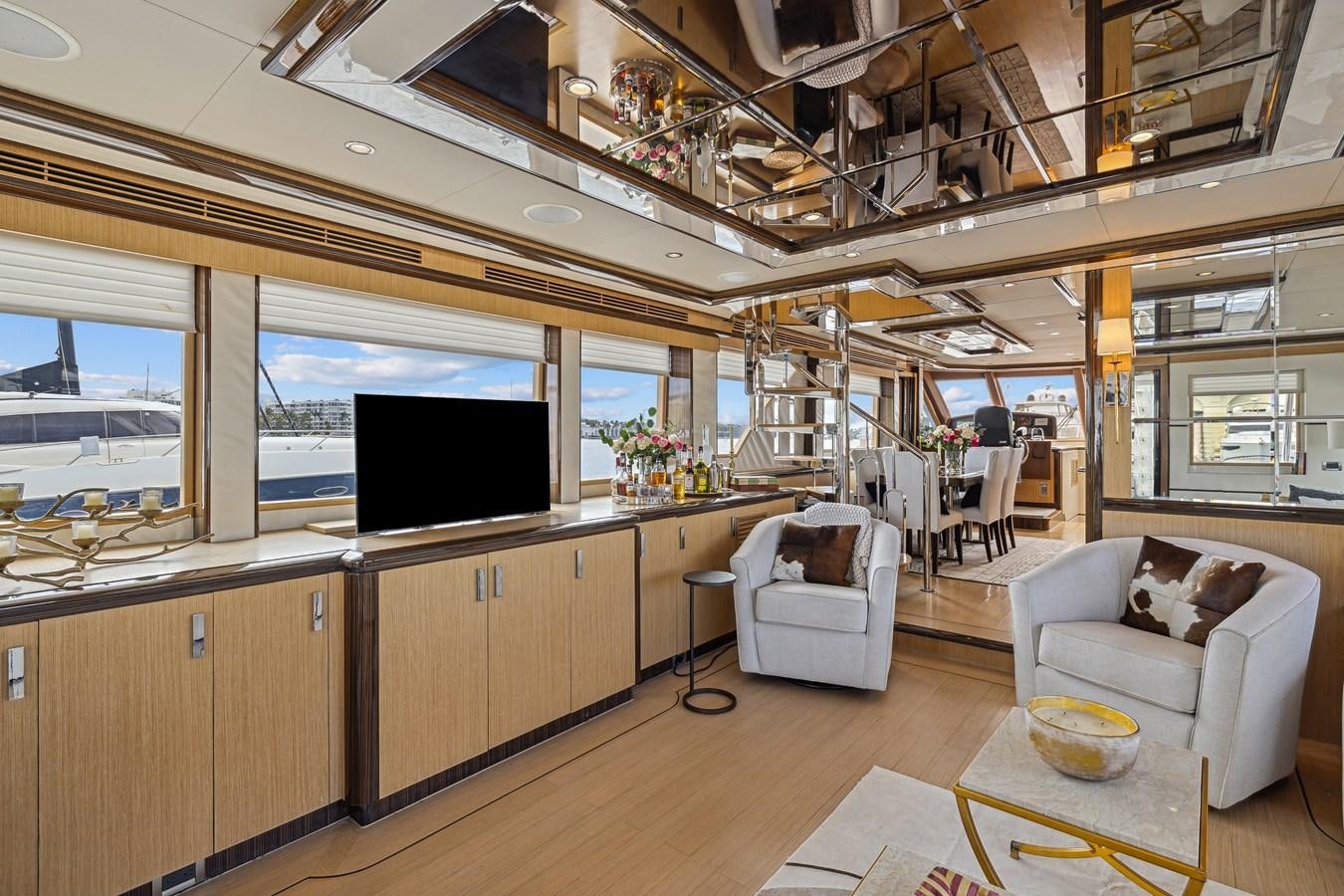 a room with a large window and a tv aboard O A Yacht for Sale