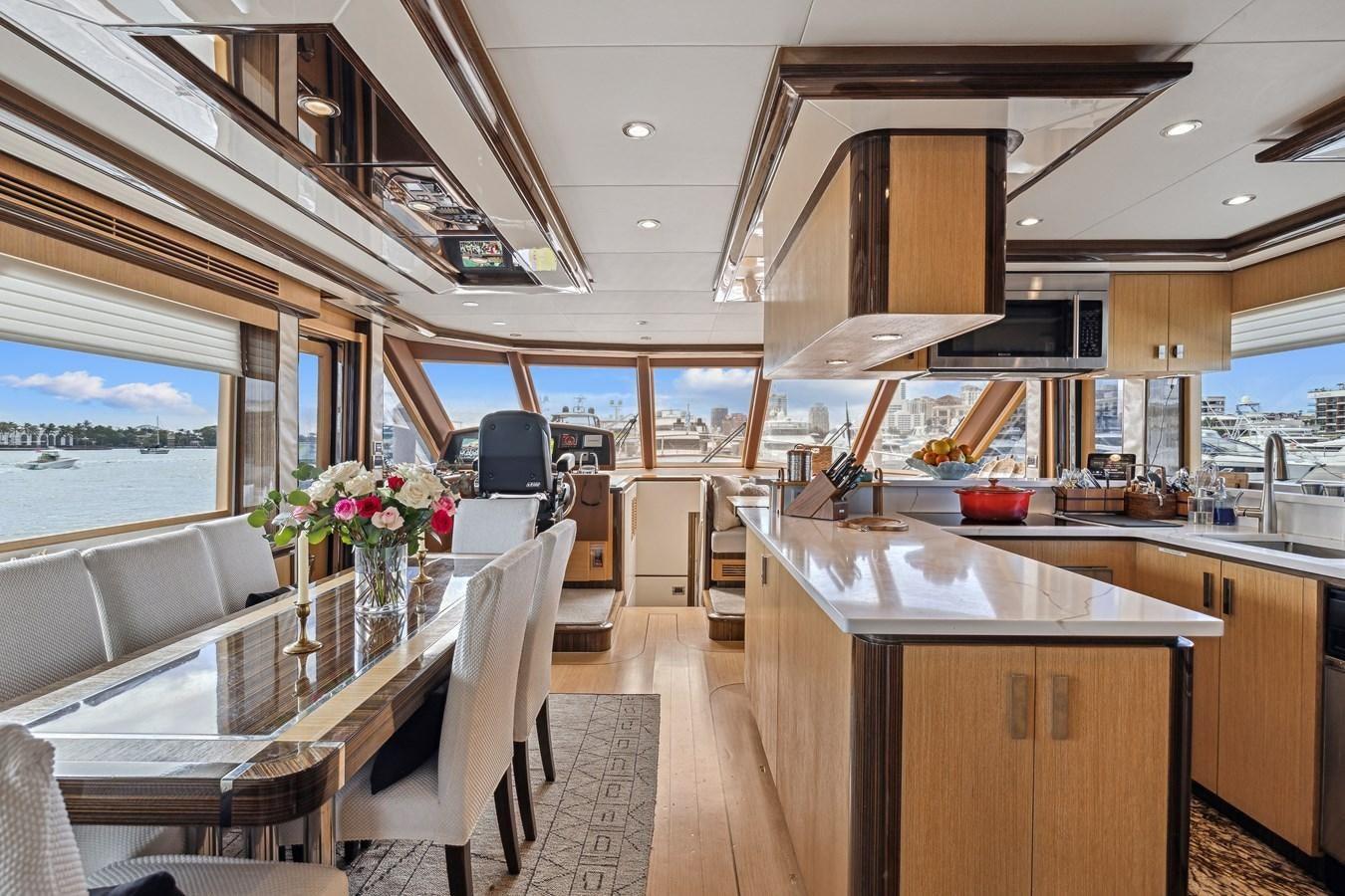 a large kitchen with a table and chairs aboard O A Yacht for Sale