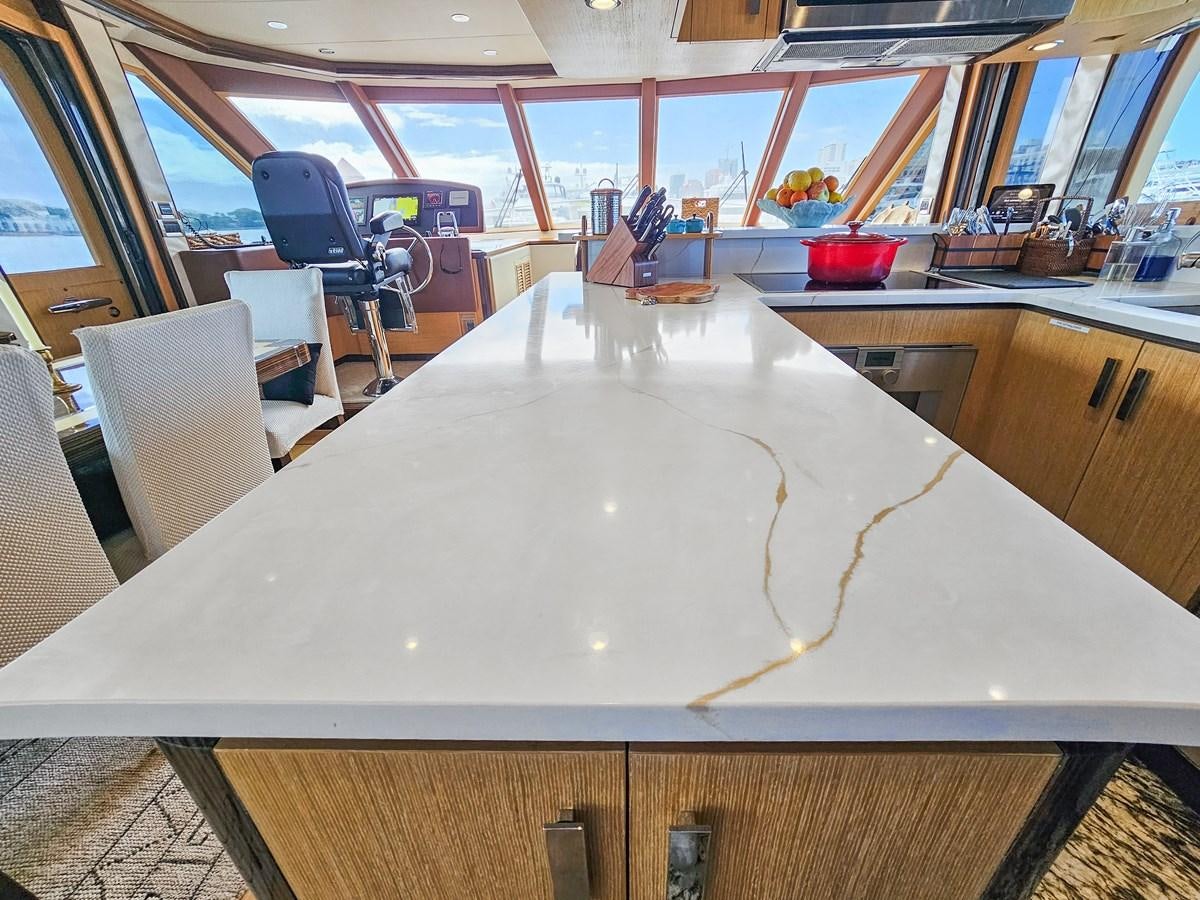 a large white cake on a table aboard O A Yacht for Sale