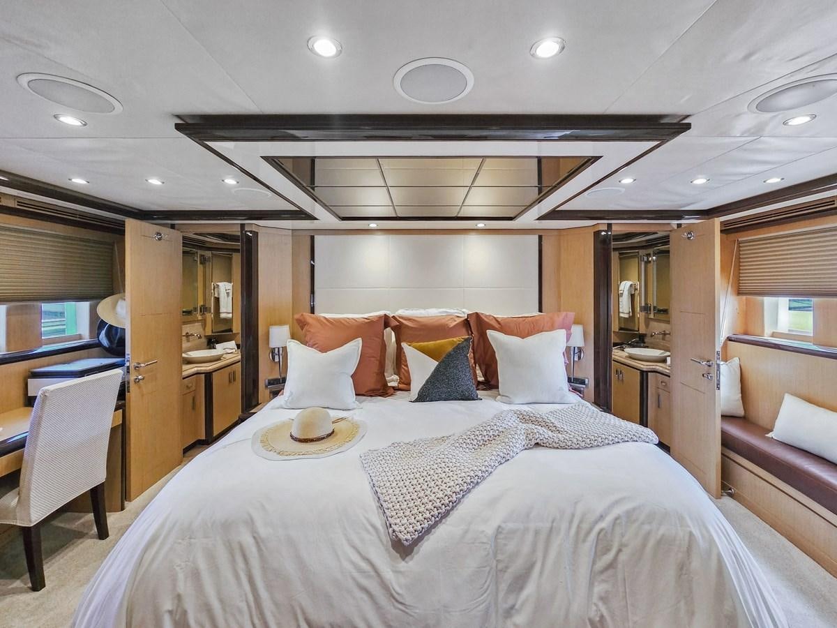 a bed with a white comforter aboard O A Yacht for Sale