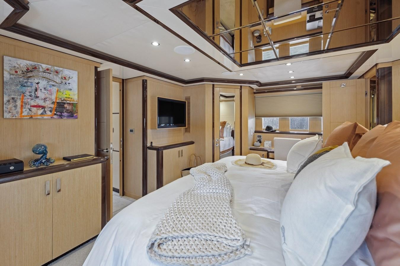 a bedroom with a bed and a television aboard O A Yacht for Sale