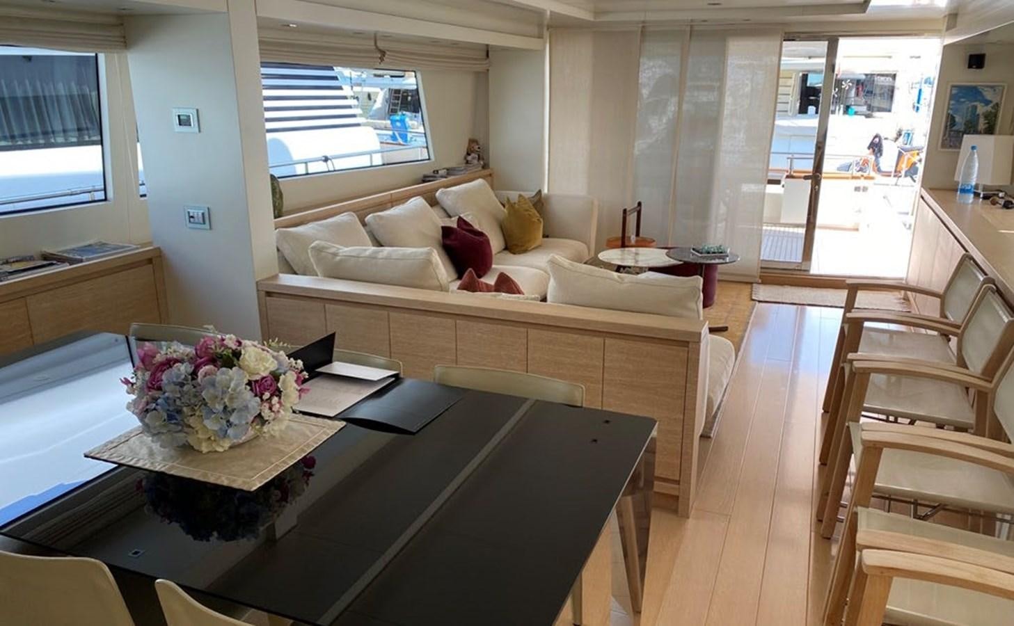 a living room with a couch and a table aboard ACCI Yacht for Sale