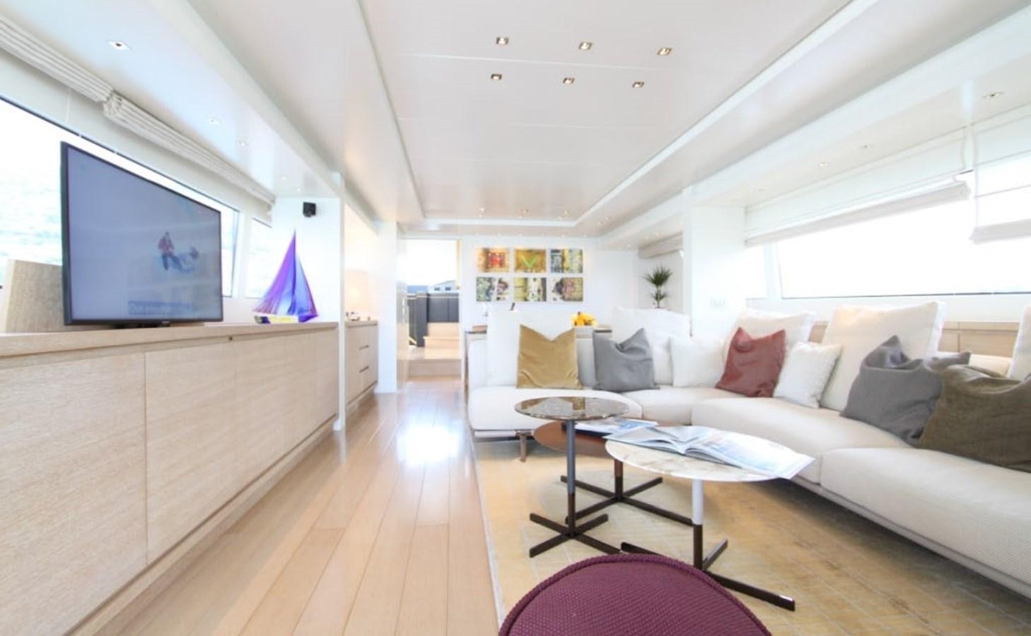 a living room with a white couch and a television aboard ACCI Yacht for Sale