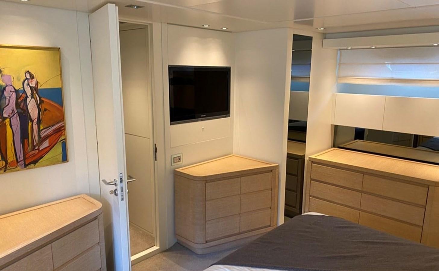 a bedroom with a bed and a tv on the wall aboard ACCI Yacht for Sale