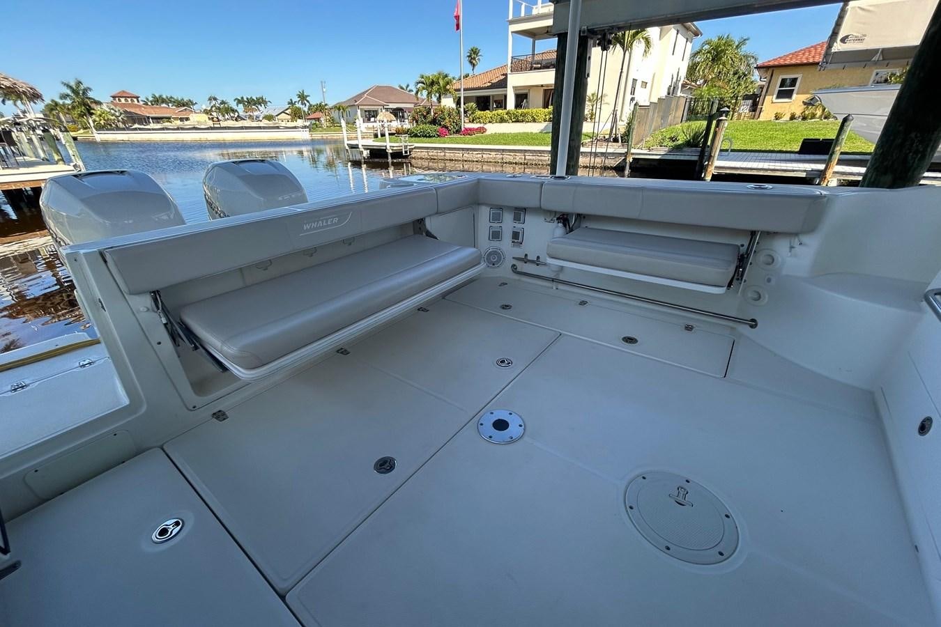 a white boat on a deck aboard B Yacht for Sale