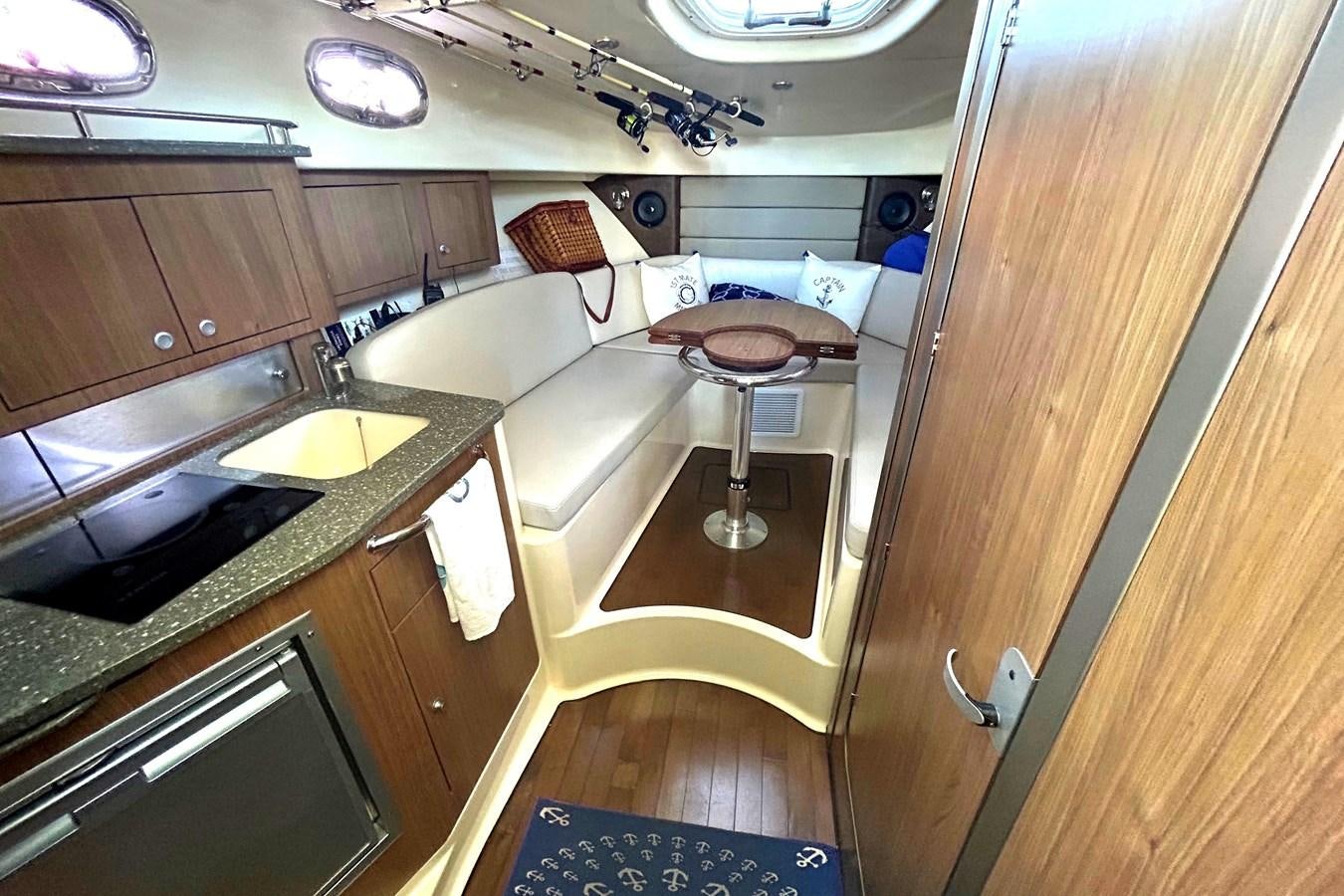 a kitchen with a sink and a table aboard B Yacht for Sale