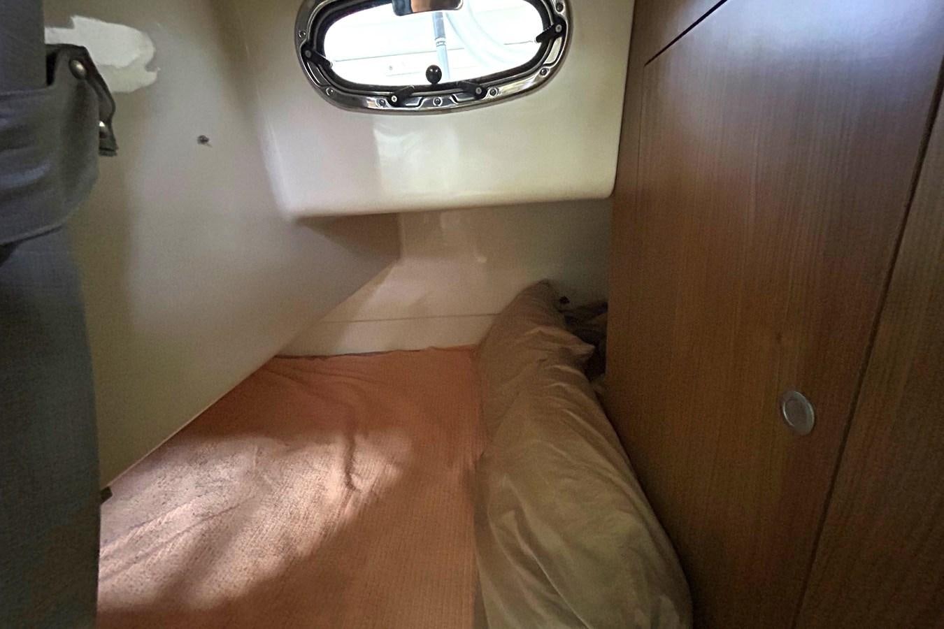 a person lying on a bed aboard B Yacht for Sale
