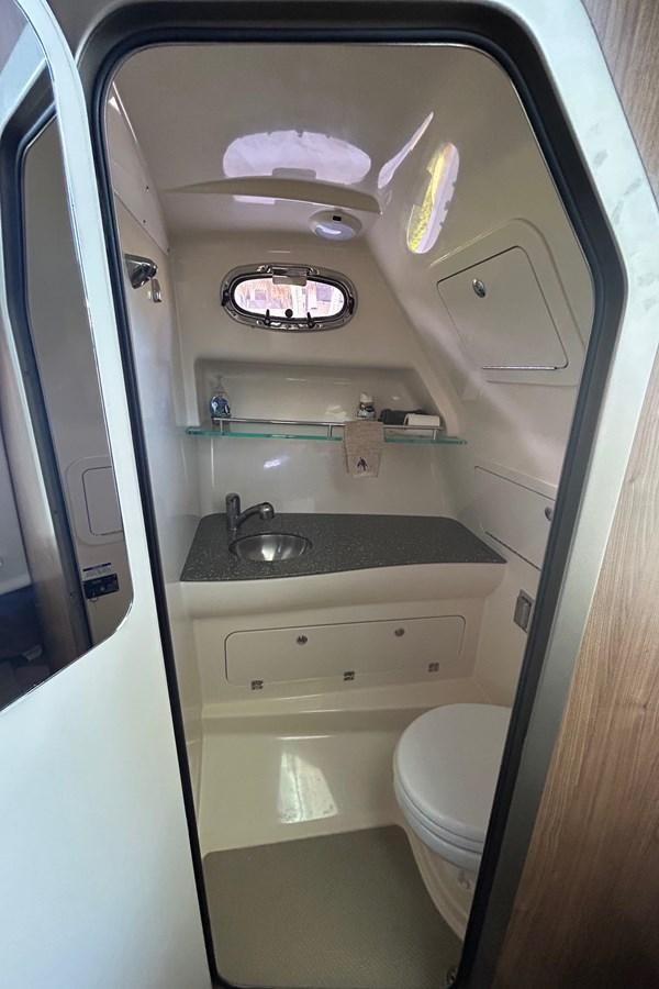 a small bathroom with a sink and toilet aboard B Yacht for Sale