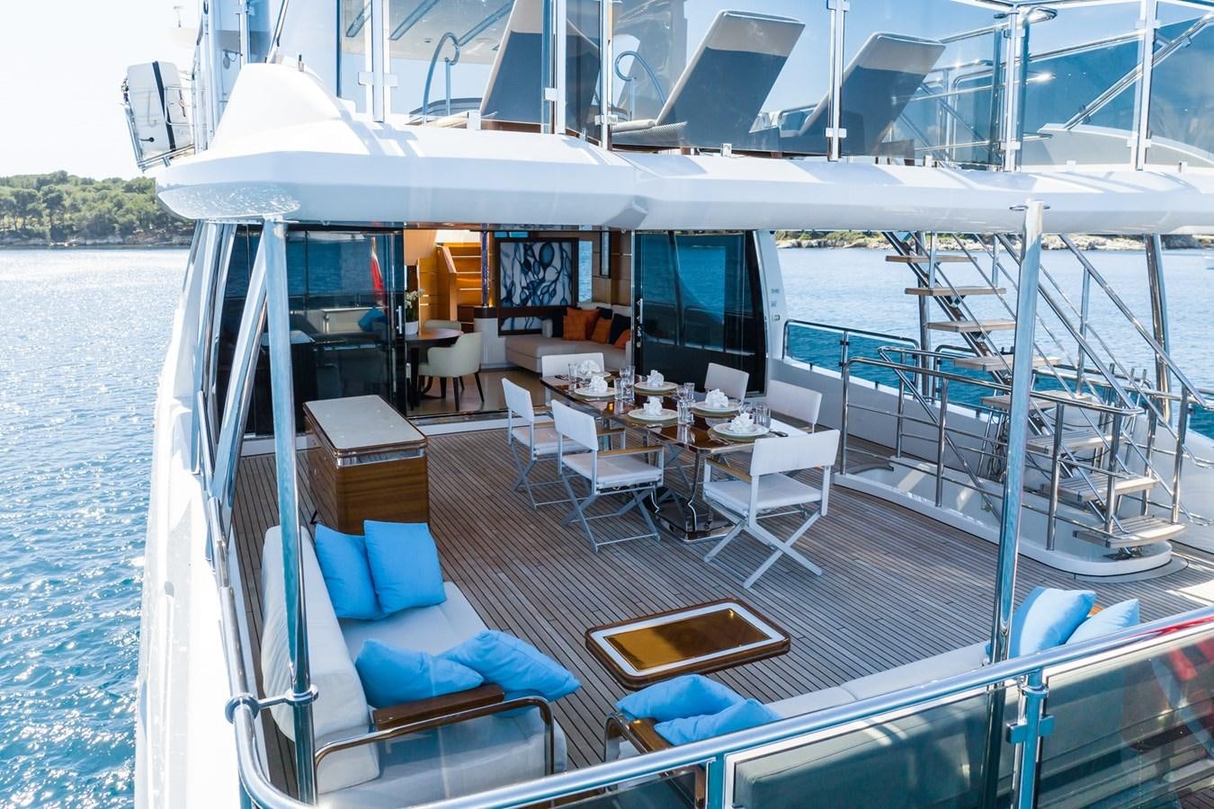 a boat with a table and chairs on the deck aboard MY PARADIS Yacht for Sale
