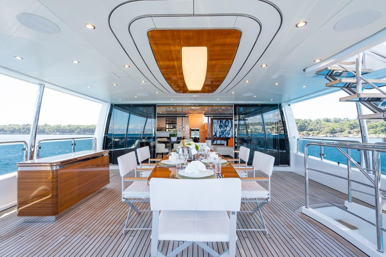 a room with a table and chairs aboard MY PARADIS Yacht for Sale