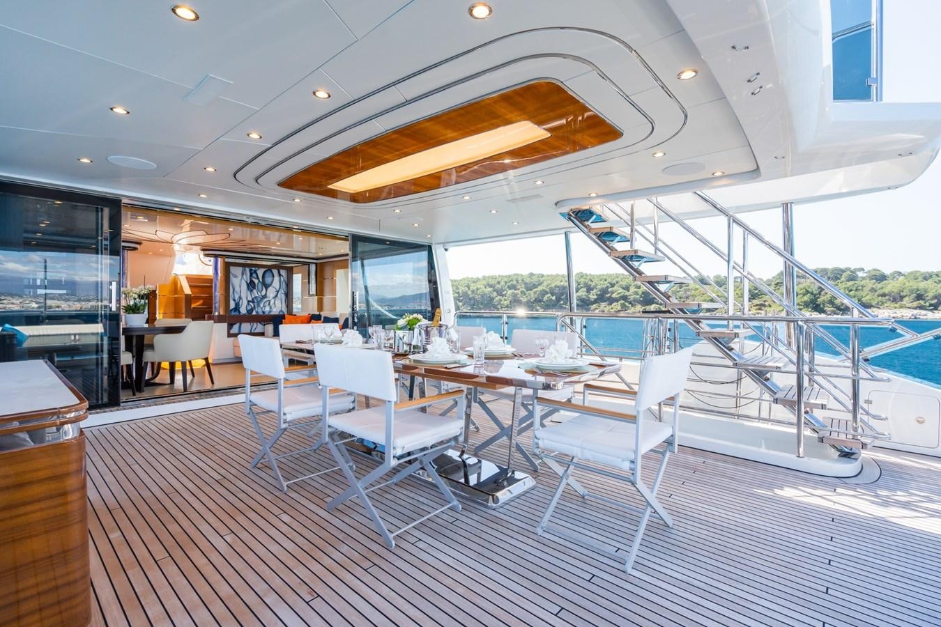 a room with a pool and chairs aboard MY PARADIS Yacht for Sale