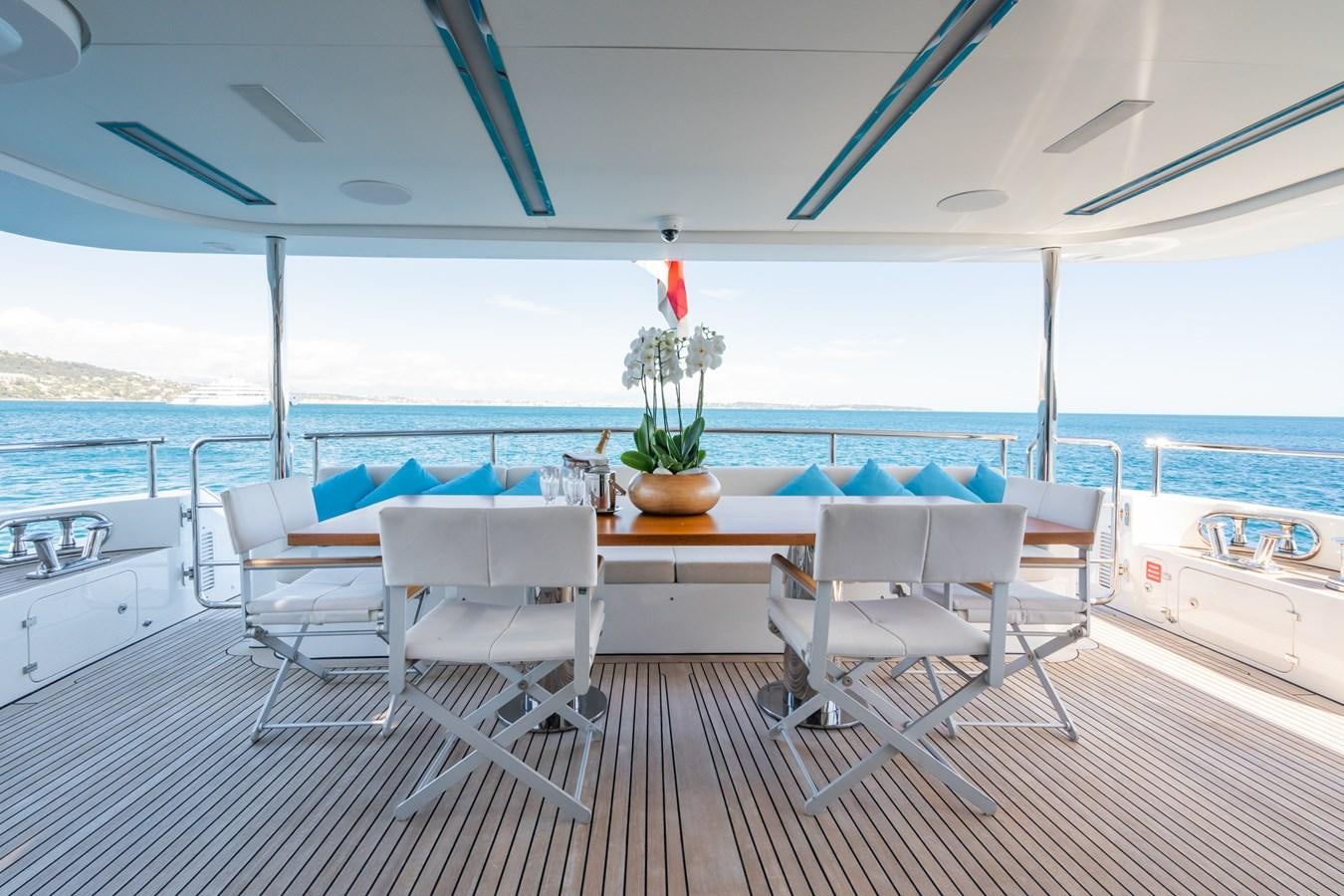 a table and chairs on a deck aboard MY PARADIS Yacht for Sale