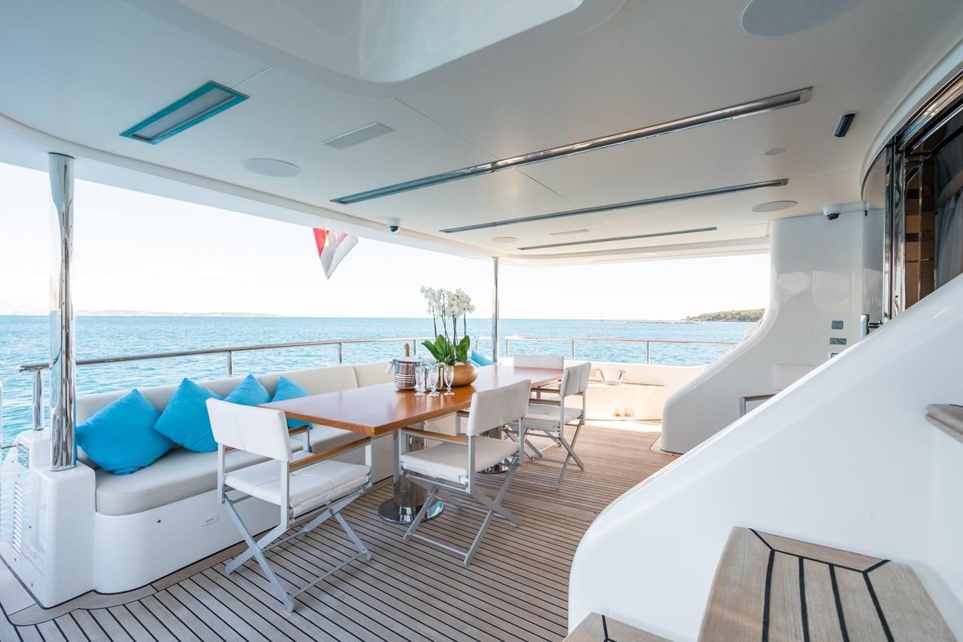 a room with a table chairs and a large body of water aboard MY PARADIS Yacht for Sale