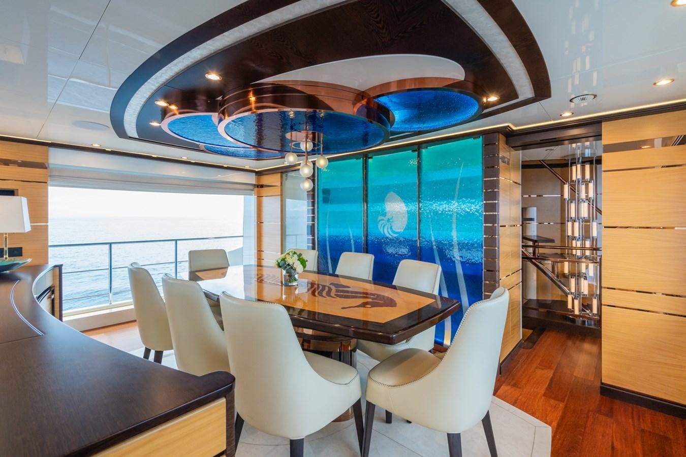 a room with a table chairs and a large umbrella aboard MY PARADIS Yacht for Sale