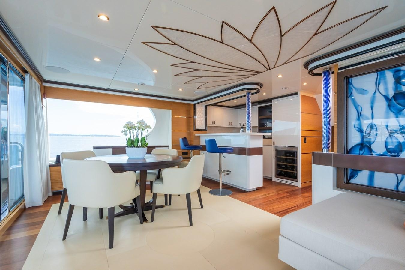 a room with a table and chairs aboard MY PARADIS Yacht for Sale