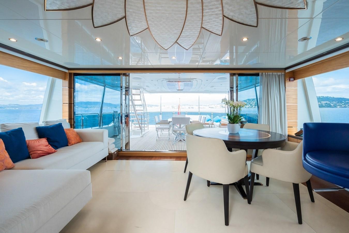 a room with a table and chairs aboard MY PARADIS Yacht for Sale
