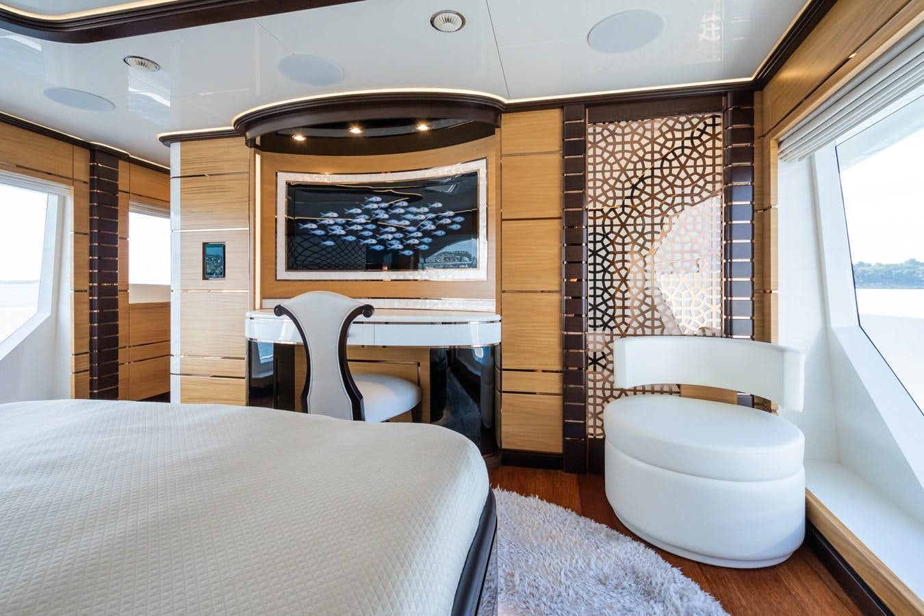 a room with a bed and a chair aboard MY PARADIS Yacht for Sale