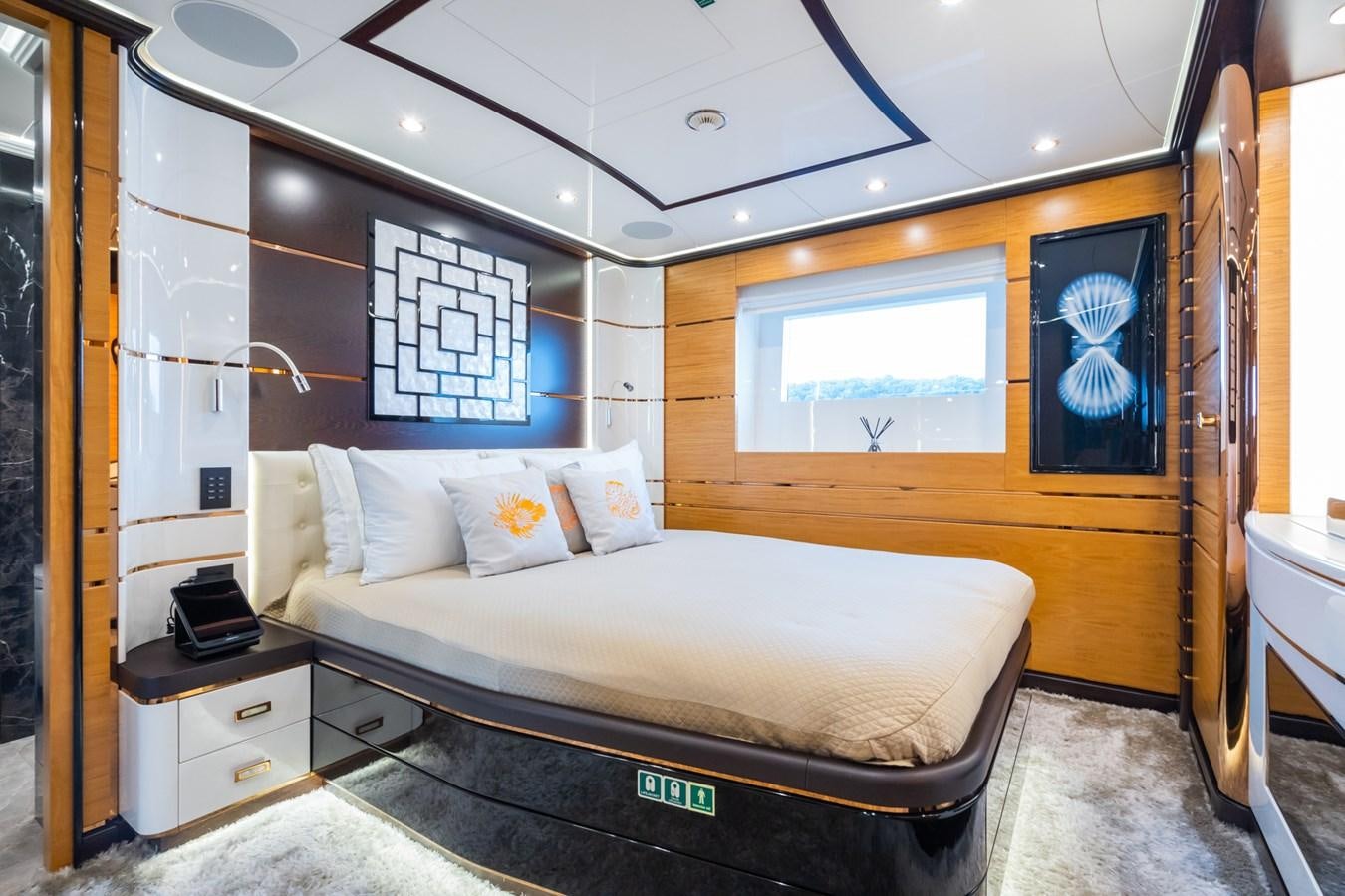 a bedroom with a bed and a desk aboard MY PARADIS Yacht for Sale