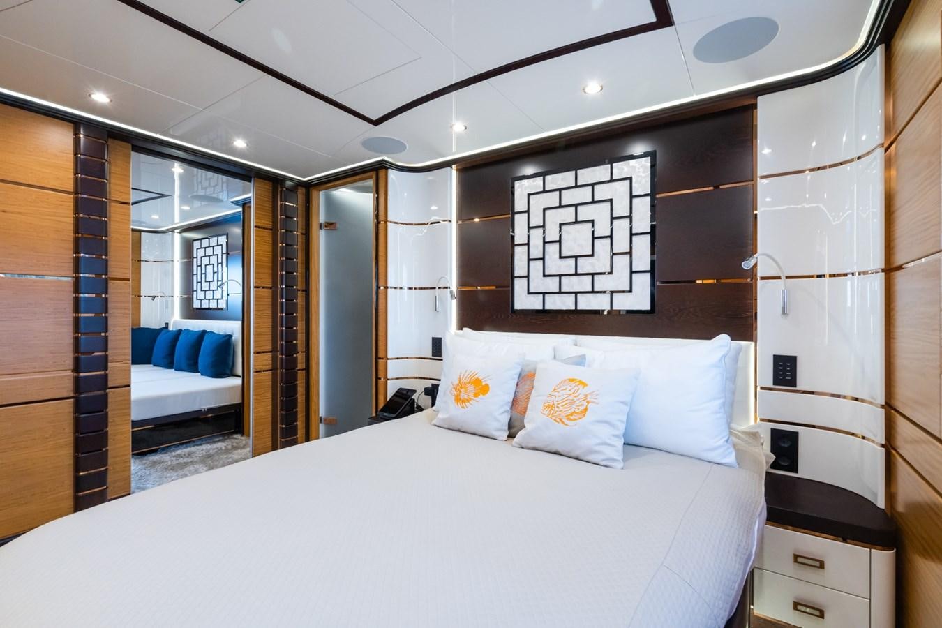 a bed with a white bed spread aboard MY PARADIS Yacht for Sale