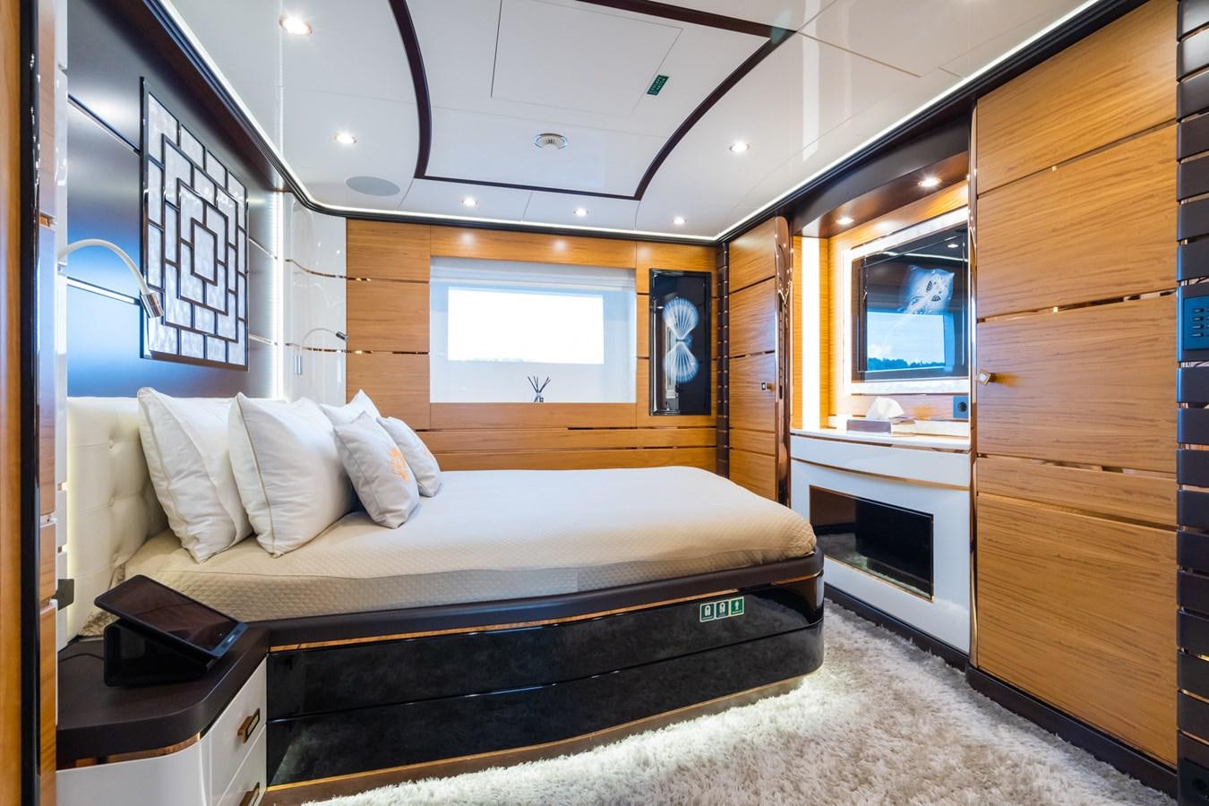 a bedroom with a bed and a desk aboard MY PARADIS Yacht for Sale