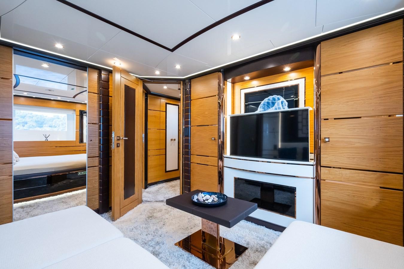 a room with a tv and a table aboard MY PARADIS Yacht for Sale