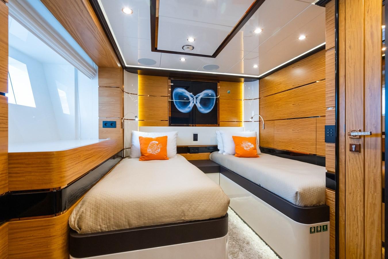 a room with a bed and a desk aboard MY PARADIS Yacht for Sale