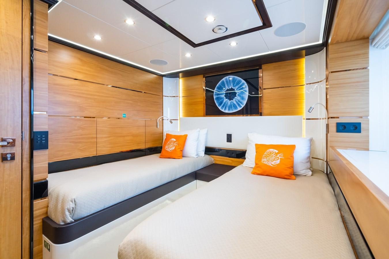 a room with a bed and a window aboard MY PARADIS Yacht for Sale