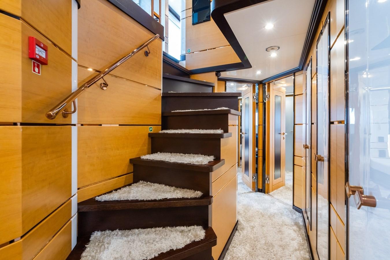 a room with wooden stairs aboard MY PARADIS Yacht for Sale
