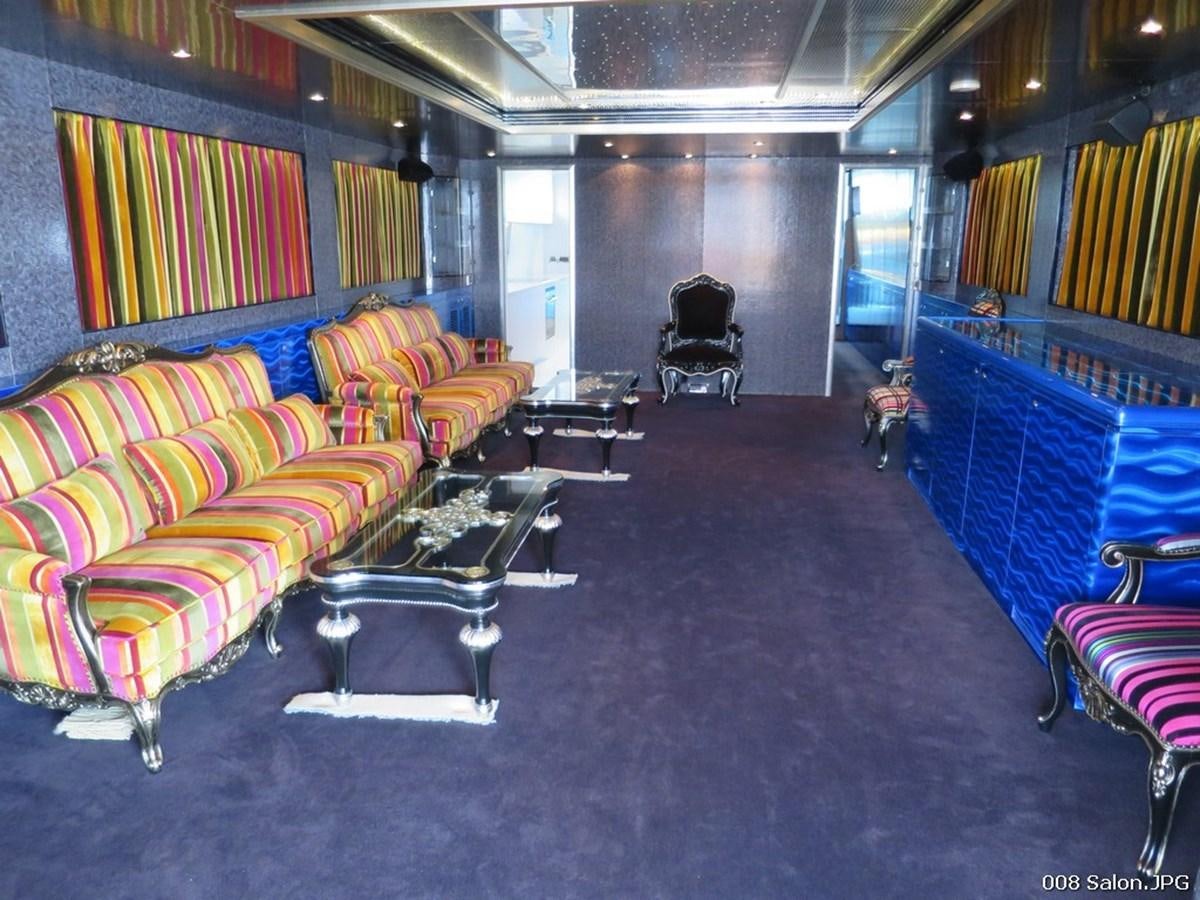 a room with a couch and chairs aboard VICTORIOUS Yacht for Sale