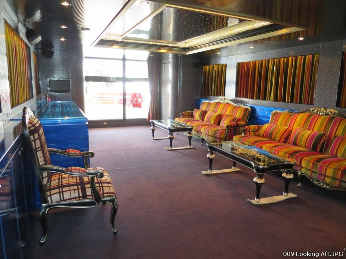 a room with couches and a table aboard VICTORIOUS Yacht for Sale