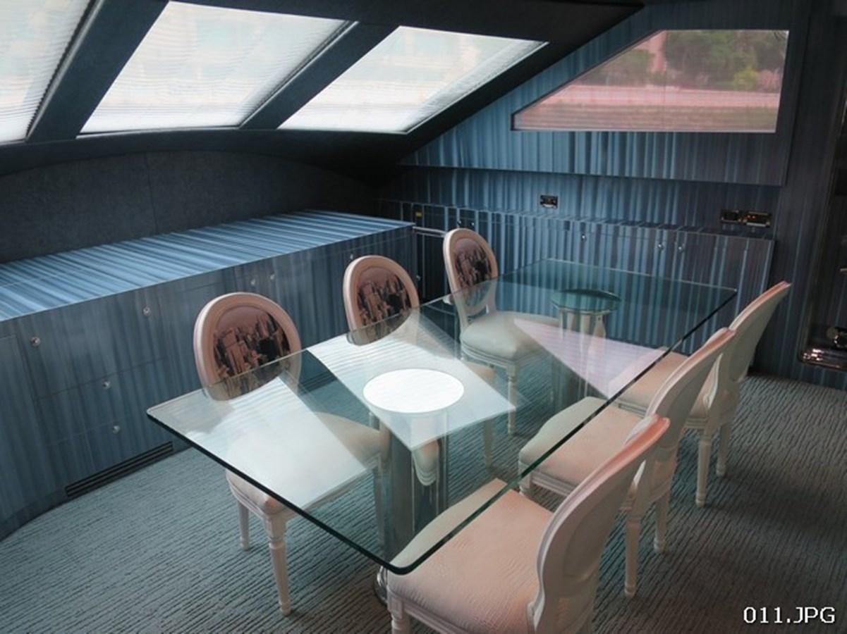 a person sitting at a table aboard VICTORIOUS Yacht for Sale