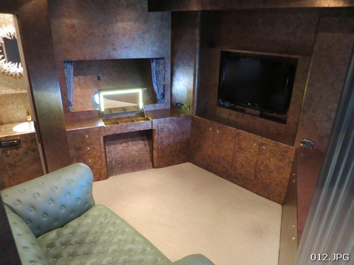 a living room with a tv aboard VICTORIOUS Yacht for Sale