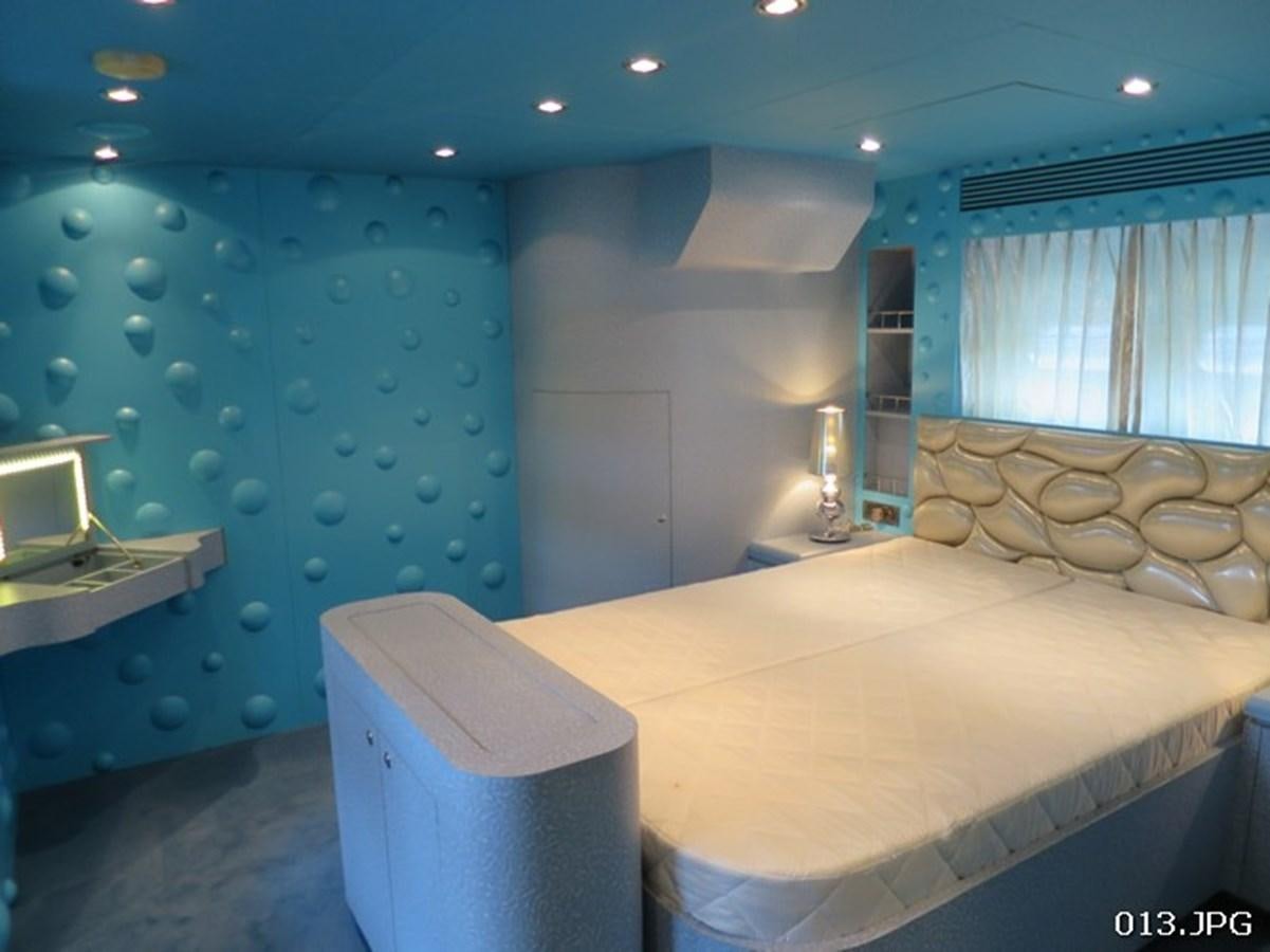a room with a bed and a window aboard VICTORIOUS Yacht for Sale