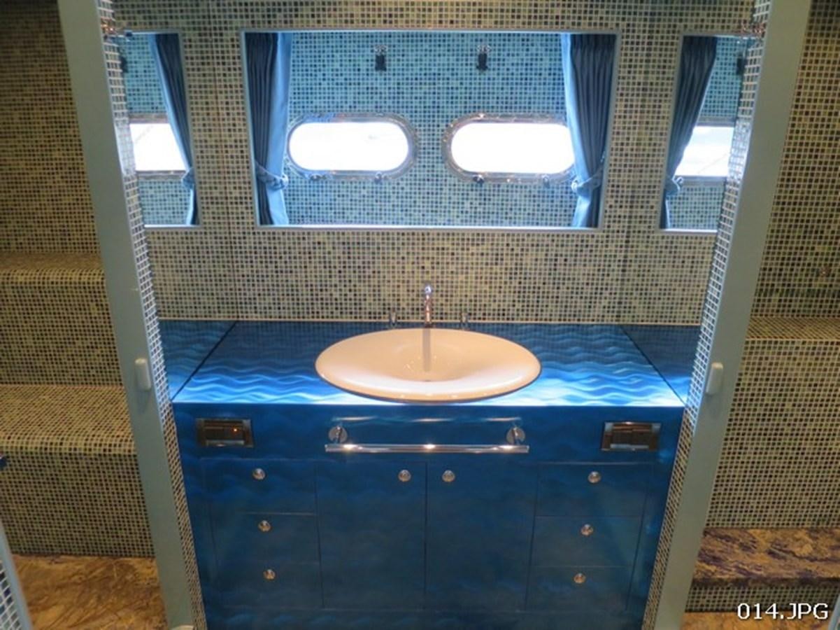 a bathroom with a sink and a mirror aboard VICTORIOUS Yacht for Sale