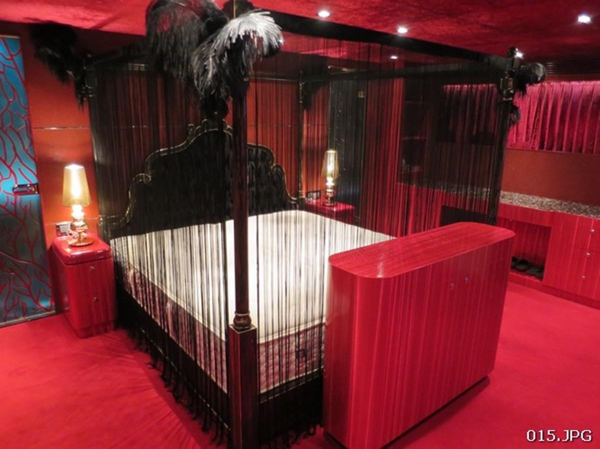 a bed with a black canopy aboard VICTORIOUS Yacht for Sale