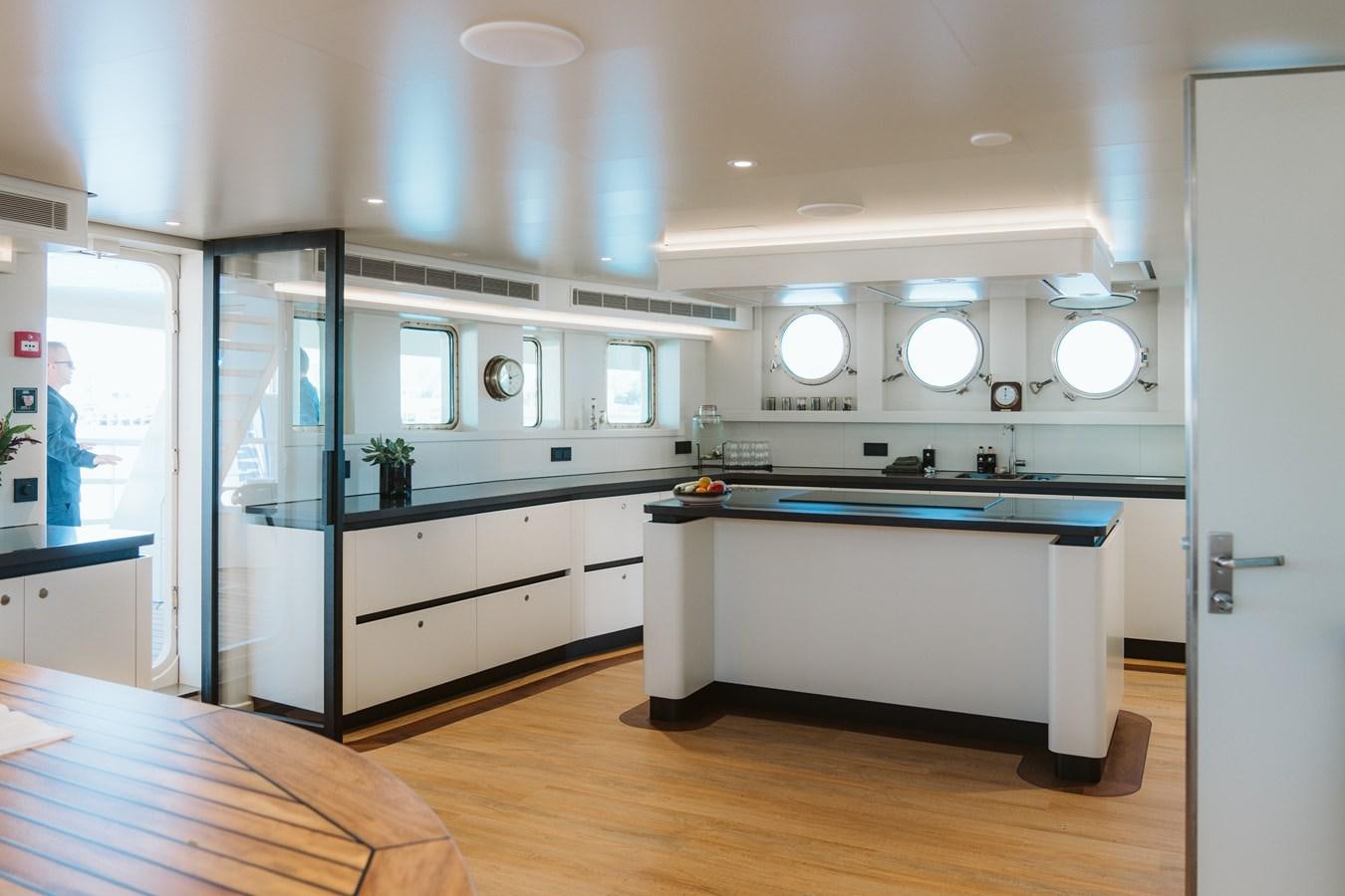 a kitchen with a large island aboard SCINTILLA MARIS Yacht for Sale
