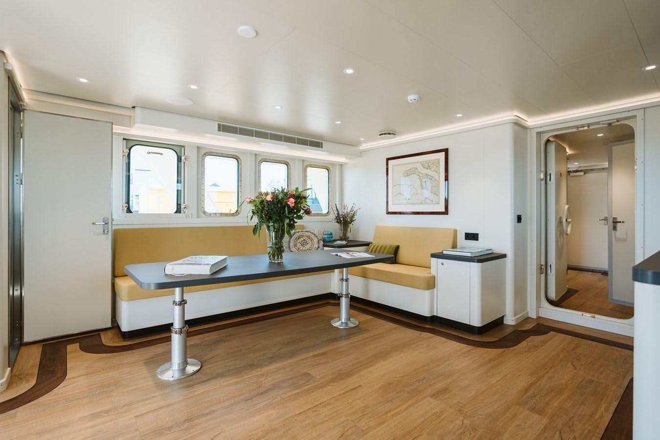 a room with a table and couch aboard SCINTILLA MARIS Yacht for Sale