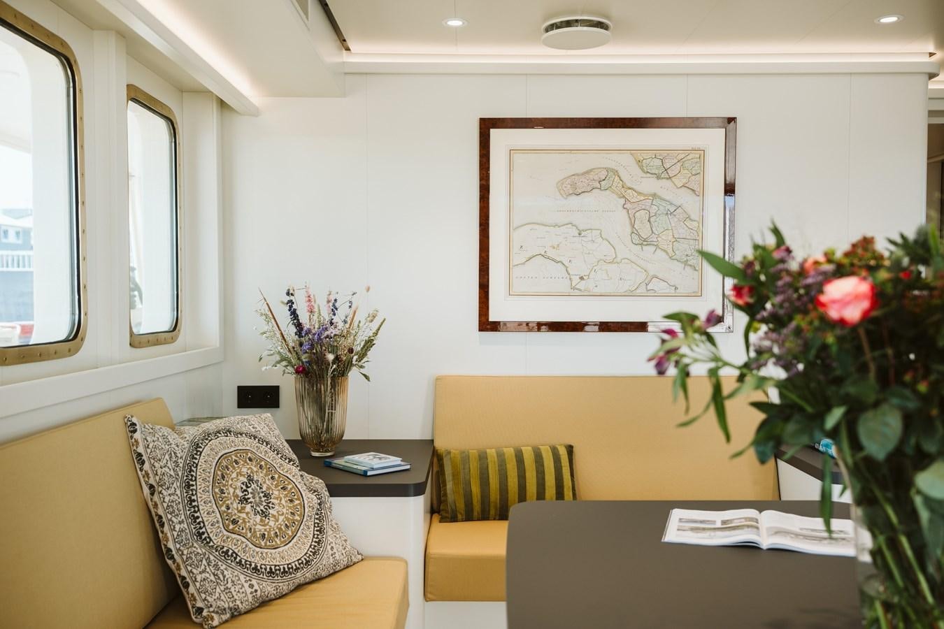 a room with a table and chairs aboard SCINTILLA MARIS Yacht for Sale