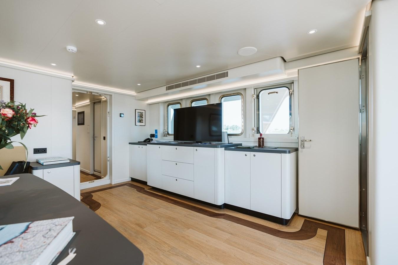 a kitchen with a tv and a table aboard SCINTILLA MARIS Yacht for Sale